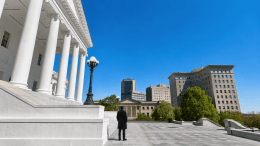 VCA News. a lone watchman in a dark overcoat stands on the steps of the Virginia State Capitol, looking out over Richmond..